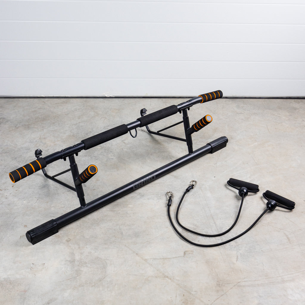 GRIND Door Mounted Pull-Up Bar on floor with resistance bands with handles.