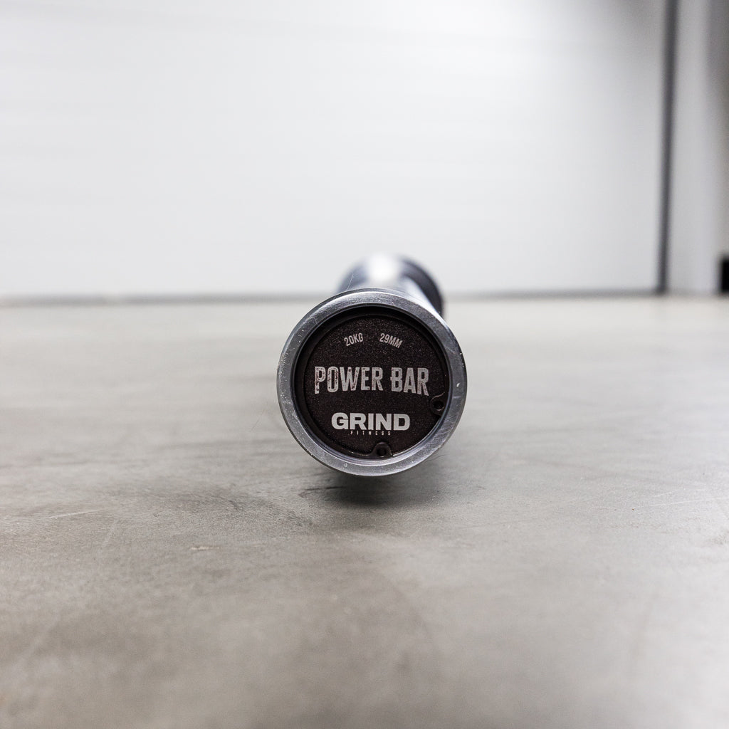GRIND Power Bar endcap with weight, bar name, and brand logo
