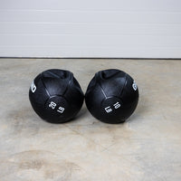 Thumbnail for 20lb and 10lb GRIND Dual-Grip Medicine Balls side by side on the floor.