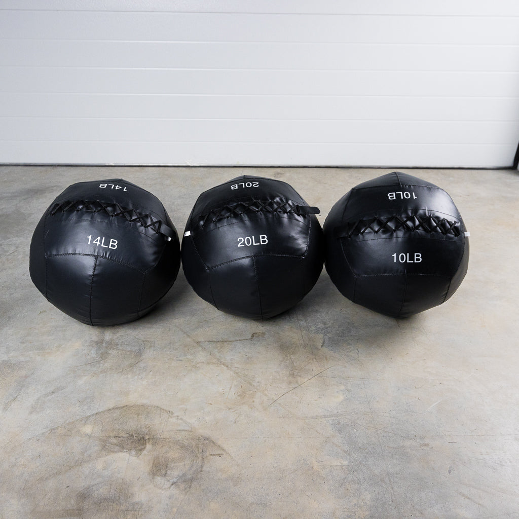 Soft Wall Balls lined up on floor - 10lb, 14lb, and 20lb