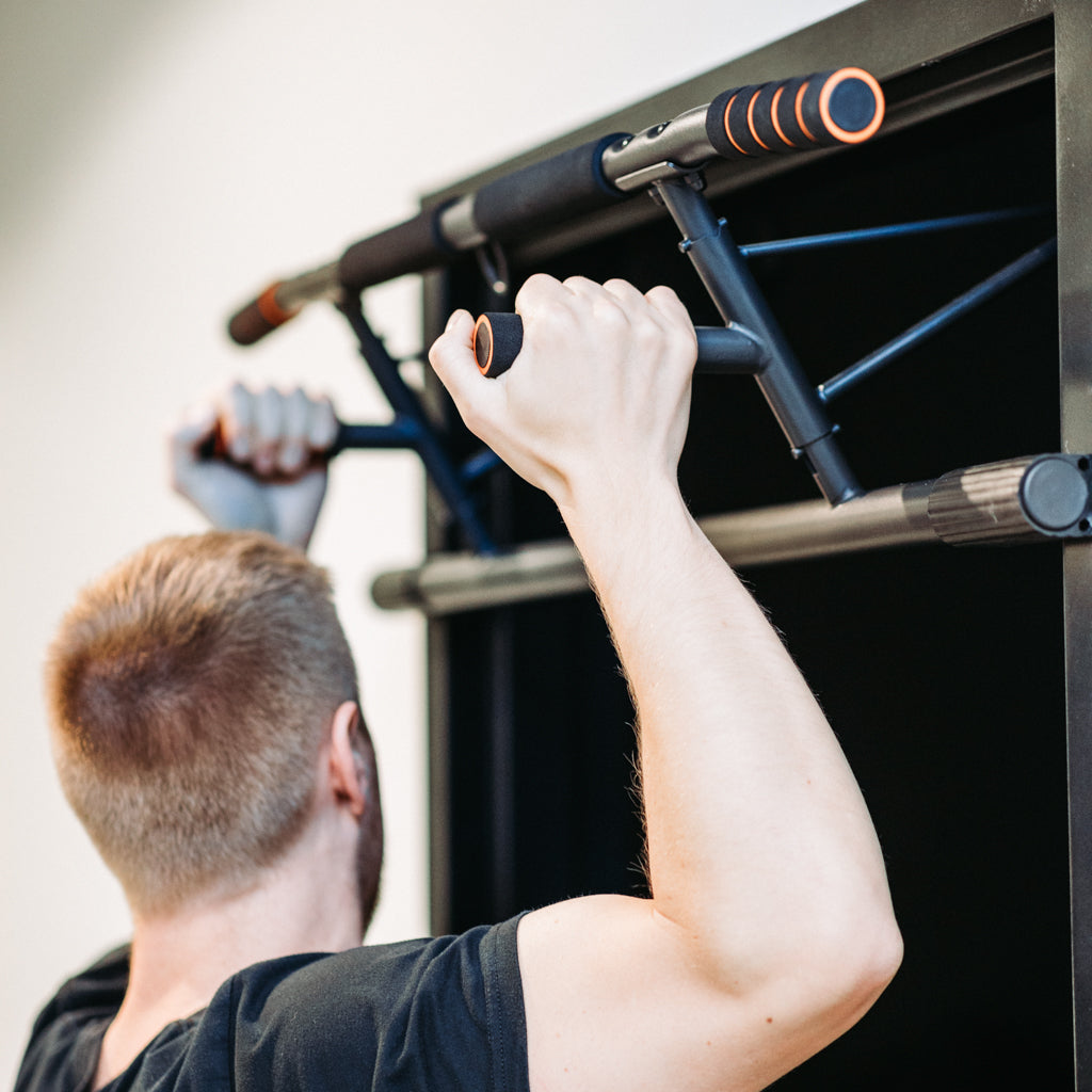 Man performing neutral grip pull up on Door Mounted Pull-Up Bar.