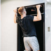 Thumbnail for Man doing wide grip pull up on Door Mounted Pull-Up Bar.