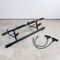 Thumbnail for GRIND Door Mounted Pull-Up Bar on floor with resistance bands with handles.