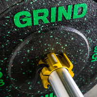 Thumbnail for yellow GRIND gripper collar locked on a barbell with a crumb rubber GRIND weight plate