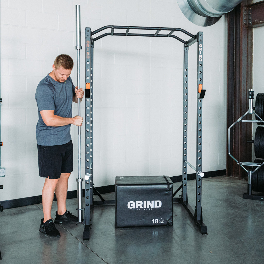 Man placing barbell in Bar Storage Attachment on Alpha3000 Squat Rack