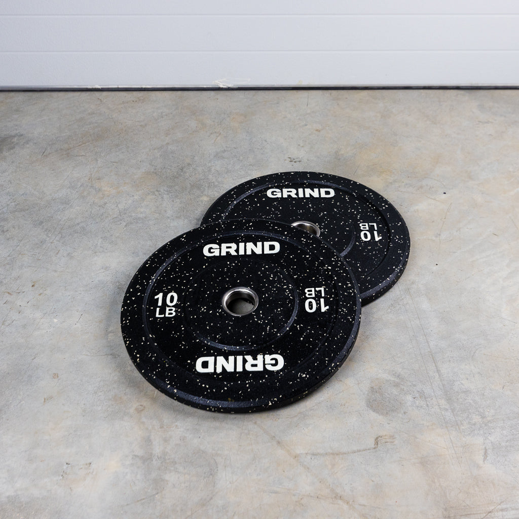 White 10lb GRIND Fitness Black Carbon Weight Plates with White Colored Fleck pieces on each plate.