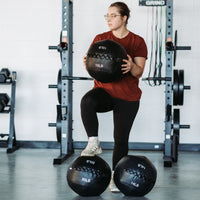Thumbnail for Person holding 10lb Soft Wall Ball with 20lb and 14lb on floor in front of them.