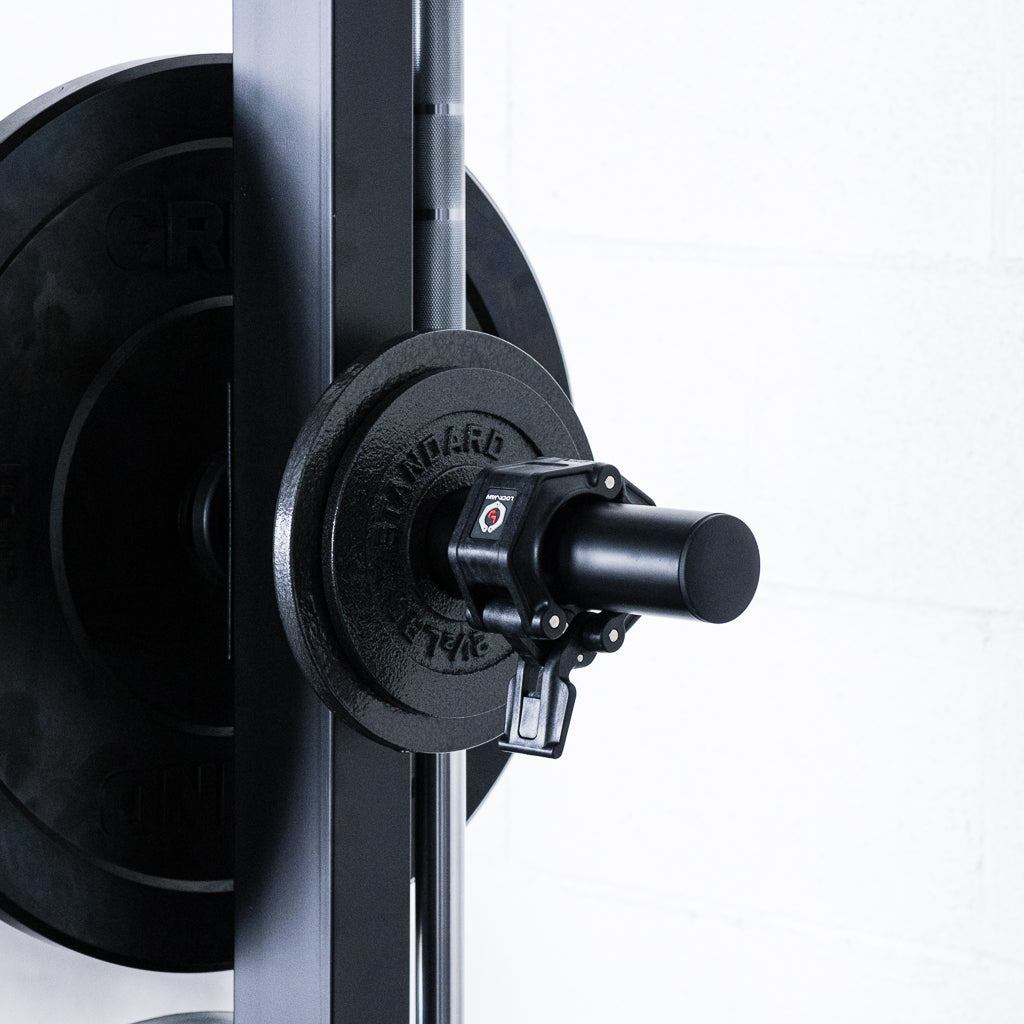 Weight peg holding change plates and barbell collar mounted to a weight lifting squat rack.