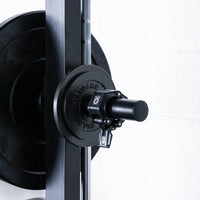 Thumbnail for Weight peg holding change plates and barbell collar mounted to a weight lifting squat rack.
